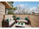 Cozy staged outdoor balcony with stylish wicker seating and a marble coffee table at 925 Elm St, Denver, CO 80220