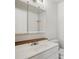 Bathroom featuring a vanity with a sink, a mirror with storage, and a toilet at 925 Elm St, Denver, CO 80220