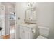 Bathroom featuring a vanity with a sink, a mirror with storage, and a toilet at 925 Elm St, Denver, CO 80220