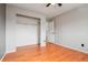 This bedroom features hardwood floors, a neutral color palette, and a large closet at 925 Elm St, Denver, CO 80220