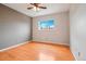 A bright bedroom with hardwood floors, a ceiling fan, and a large window at 925 Elm St, Denver, CO 80220
