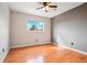 This bedroom features hardwood floors, a neutral color palette, and a ceiling fan at 925 Elm St, Denver, CO 80220