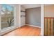Bright bonus room featuring hardwood floors, two display shelves, and a large window with natural light at 925 Elm St, Denver, CO 80220