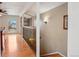 Hallway featuring hardwood floors and decorative metal railing leading to the living room at 925 Elm St, Denver, CO 80220
