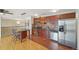 Open kitchen with stainless steel appliances, granite counters, tile backsplash, and eat-in breakfast bar at 925 Elm St, Denver, CO 80220