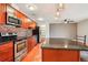 Updated kitchen with stainless steel appliances, wooden cabinets, and granite countertops at 925 Elm St, Denver, CO 80220