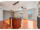 Open living area with a kitchen island, ceiling fans, and great natural light at 925 Elm St, Denver, CO 80220