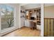 Bright home office with built-in shelving and a large window at 925 Elm St, Denver, CO 80220