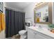 Bathroom featuring a white vanity, patterned shower curtain, and tiled flooring at 4460 S Pitkin St # 119, Aurora, CO 80015