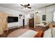 Bedroom featuring hardwood floors, neutral tones, a ceiling fan, and a large mirror at 4460 S Pitkin St # 119, Aurora, CO 80015