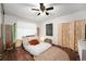 Well-lit bedroom with hardwood floors, neutral tones, and a ceiling fan at 4460 S Pitkin St # 119, Aurora, CO 80015