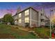Exterior view of gray apartments featuring private balconies and landscaped front yard at 4460 S Pitkin St # 119, Aurora, CO 80015