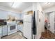 Cozy kitchen featuring light blue cabinets, white appliances, and granite countertops at 4460 S Pitkin St # 119, Aurora, CO 80015