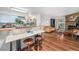 Cozy living room and kitchen combined with hardwood floors and balcony access at 4460 S Pitkin St # 119, Aurora, CO 80015