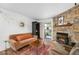 Inviting living room with stone fireplace, stylish rug, and cozy seating area at 4460 S Pitkin St # 119, Aurora, CO 80015