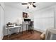 Office space featuring hardwood floors, neutral walls, and a large window at 4460 S Pitkin St # 119, Aurora, CO 80015