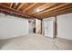 Unfinished basement with wrapped walls and ceiling, including a white refrigerator at 10681 Cherrybrook Cir, Highlands Ranch, CO 80126