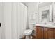 Well-lit bathroom with a shower/tub, dark wood vanity, and tiled floor at 10681 Cherrybrook Cir, Highlands Ranch, CO 80126