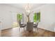 Bright dining room featuring a chandelier, glass table, and sliding door to the outside at 10681 Cherrybrook Cir, Highlands Ranch, CO 80126