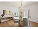 Bright dining room featuring a chandelier, glass table, and sliding door to the outside at 10681 Cherrybrook Cir, Highlands Ranch, CO 80126