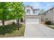 Charming two-story home boasts stone accents, a well-manicured lawn, and a spacious two-car garage at 10681 Cherrybrook Cir, Highlands Ranch, CO 80126