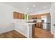 Well-lit kitchen with wood cabinets, stainless steel appliances, and breakfast bar at 10681 Cherrybrook Cir, Highlands Ranch, CO 80126