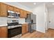 Kitchen featuring stainless appliances and wood cabinets at 10681 Cherrybrook Cir, Highlands Ranch, CO 80126