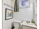 Small basement bathroom with white vanity and toilet at 826 S York St, Denver, CO 80209