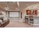 Finished basement with home theatre setup, wet bar, and comfortable seating at 13360 W 83Rd Pl, Arvada, CO 80005