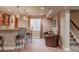 Finished basement area featuring a wet bar, seating area, and stairs at 13360 W 83Rd Pl, Arvada, CO 80005