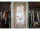 View from closet to bathroom featuring large soaking tub and tile floor at 13360 W 83Rd Pl, Arvada, CO 80005
