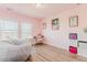 Bright pink bedroom with two large windows, desk, and seating at 13360 W 83Rd Pl, Arvada, CO 80005