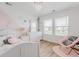 Cozy bedroom with accent wall, modern lighting, and ample natural light at 13360 W 83Rd Pl, Arvada, CO 80005