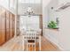 Elegant dining room featuring a modern chandelier, hardwood floors, and large windows for natural light at 13360 W 83Rd Pl, Arvada, CO 80005