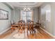 Formal dining room boasts beautiful hardwood floors and stylish chandelier at 13360 W 83Rd Pl, Arvada, CO 80005