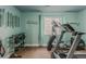 Workout room with modern exercise equipment and inspirational quote wall decor at 13360 W 83Rd Pl, Arvada, CO 80005