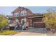 Beautiful two-story home with a well-manicured front yard and a charming front porch at 13360 W 83Rd Pl, Arvada, CO 80005