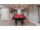Game room with a pool table with window seating and storage at 13360 W 83Rd Pl, Arvada, CO 80005