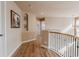 Hallway with hardwood floors leads to various rooms at 13360 W 83Rd Pl, Arvada, CO 80005