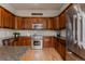 Gourmet kitchen with custom wood cabinets, stainless steel appliances, and granite countertops at 13360 W 83Rd Pl, Arvada, CO 80005