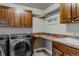 Laundry room featuring a modern washer and dryer, cabinets, and countertop space at 13360 W 83Rd Pl, Arvada, CO 80005