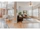 Open-concept living room and dining area with hardwood floors and stylish furnishings at 13360 W 83Rd Pl, Arvada, CO 80005