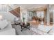 Well-decorated living room adjacent to dining area with an archway, perfect for entertaining at 13360 W 83Rd Pl, Arvada, CO 80005
