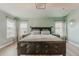 Main bedroom featuring windows, tray ceiling and hardwood flooring at 13360 W 83Rd Pl, Arvada, CO 80005