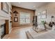 Bright office features built-in shelves, fireplace, and a modern glass desk at 13360 W 83Rd Pl, Arvada, CO 80005