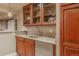 Basement wet bar features granite countertops, wood cabinets, and a beverage refrigerator at 13360 W 83Rd Pl, Arvada, CO 80005