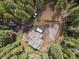 Aerial view showcases a home with a wooden deck and surrounding construction site at 8905 Carol Ln, Conifer, CO 80433