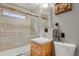 Bathroom featuring shower over tub, updated fixtures and tile work at 8905 Carol Ln, Conifer, CO 80433