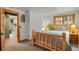Bedroom with carpeted floors, wood trim, and access to laundry room at 8905 Carol Ln, Conifer, CO 80433