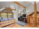 Bedroom features vaulted ceilings, exposed beams, a desk, and access to a balcony at 8905 Carol Ln, Conifer, CO 80433